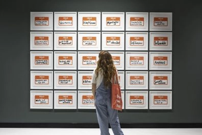 Visitor viewing "HELLO I am Robbie Williams" artwork installation at Moco Museum Barcelona