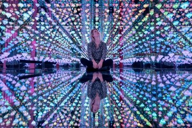 Visitor admiring the colorful diamond immersive room by Studio Irma.